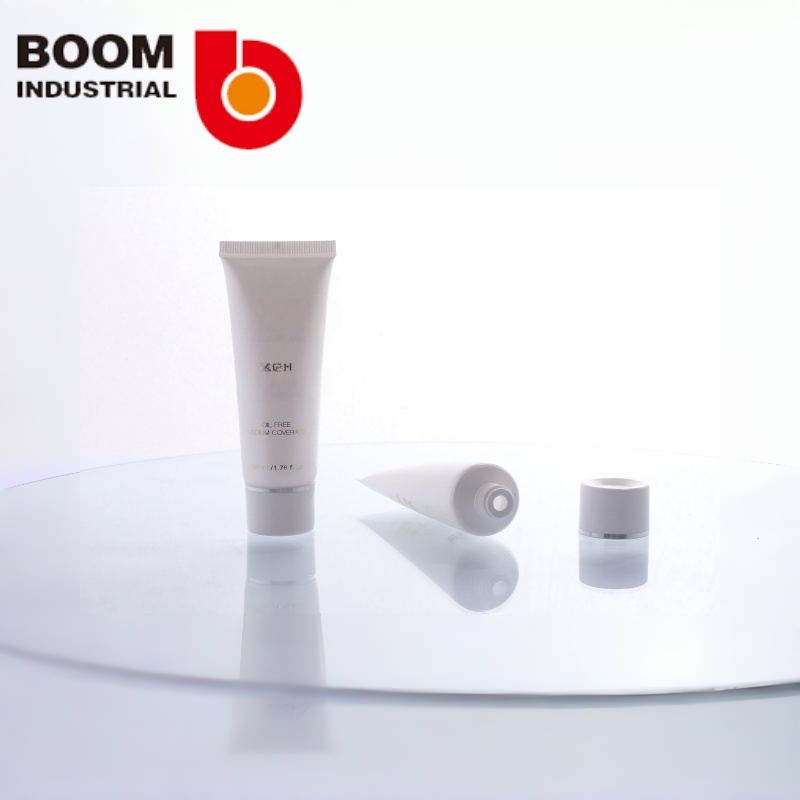 White pearlescent tube, 30 mm diameter, with gold foil stamping and silver foil stamping on the twist cap.