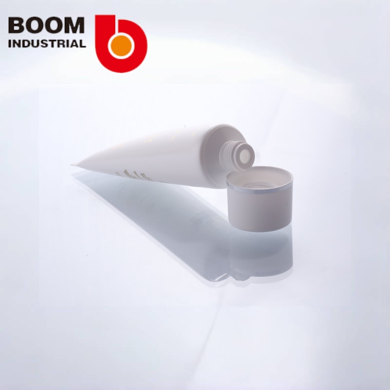 White pearlescent tube, 30 mm diameter, with gold foil stamping and silver foil stamping on the twist cap.