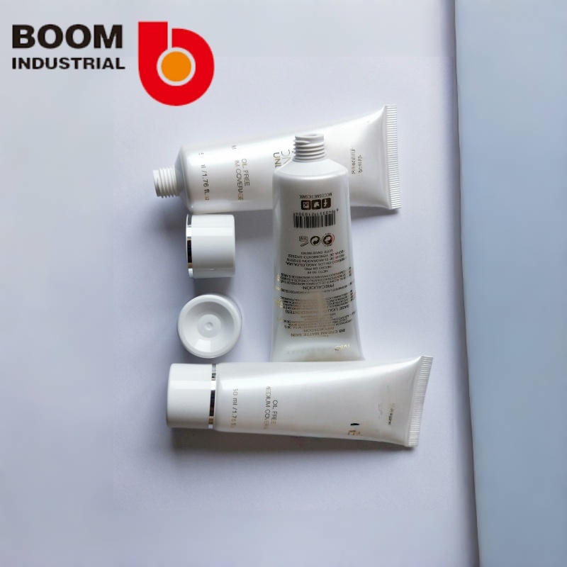 White pearlescent tube, 30 mm diameter, with gold foil stamping and silver foil stamping on the twist cap.